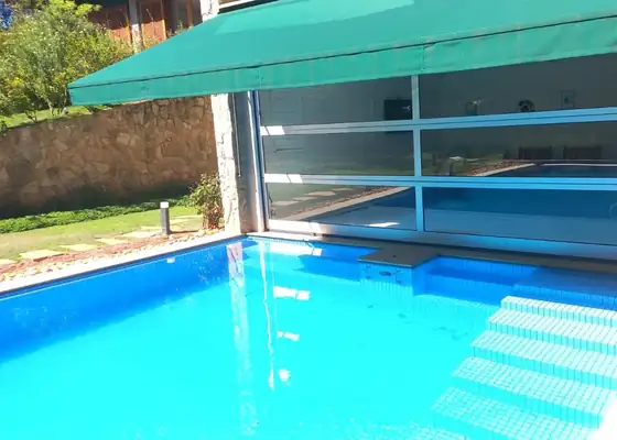 Esquadrias de vidro em área de piscina coberta, obra da PS do Vidro