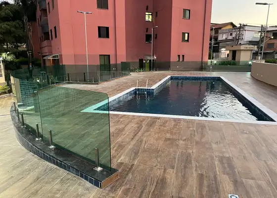 Guarda-corpo de vidro com torres de inox na área da piscina, obra da PS do Vidro